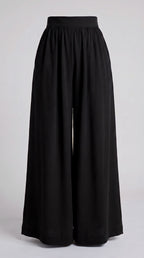 Black wide-leg cropped pants with a gathered elastic waistband, shown against a light gray studio background.