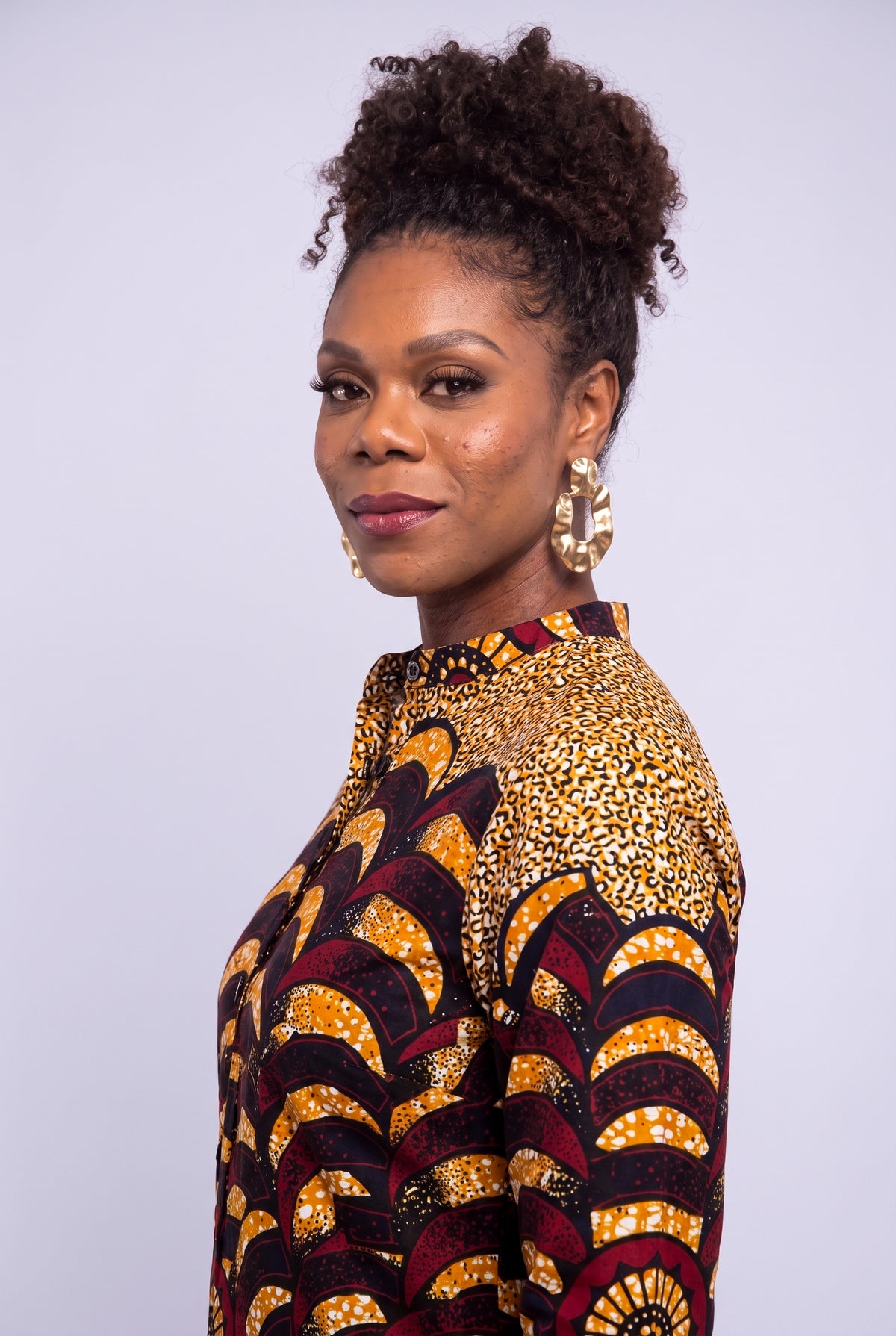 Side close up of Saffron Halo African print long sleeve shirt dress showing the structured collar and wax print