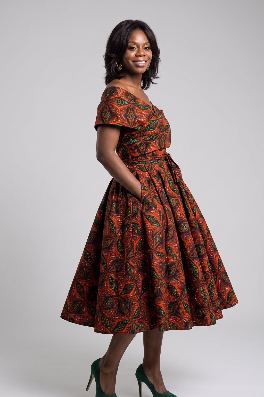 Side view of orange green navy and copper Ankara midi dress
