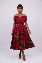 Walking in red African print midi off shoulder dress showing skirt movement