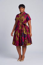 Side view of pink navy and gold Ankara wrap midi dress