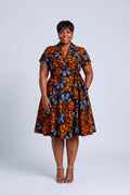 Front view plus size model wearing Marigold Bloom African wrap dress