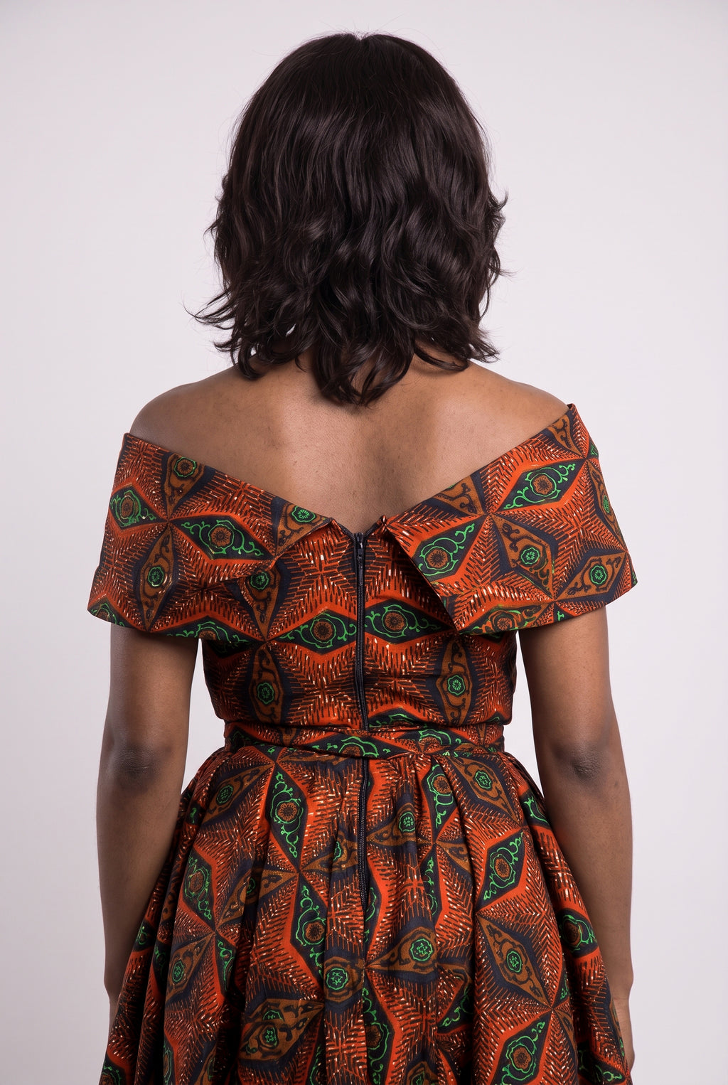 Back view of orange African print off shoulder midi dress