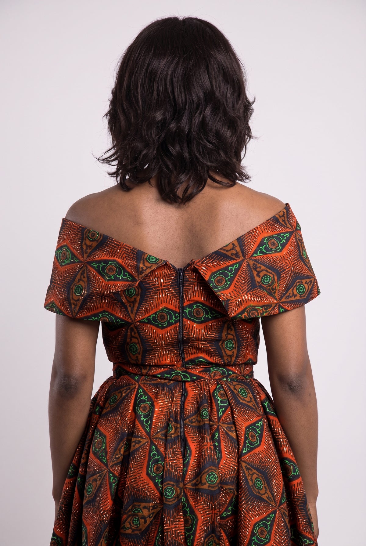 Back view of orange African print off shoulder midi dress