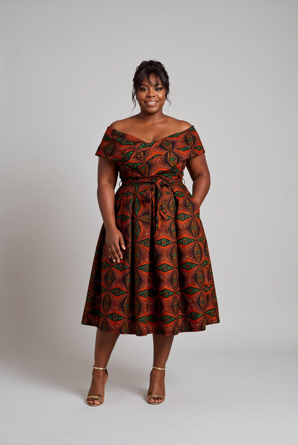 Plus size model wearing Copper Star Ankara wedding guest dress
