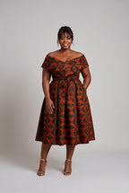 Plus size model wearing Copper Star Ankara wedding guest dress