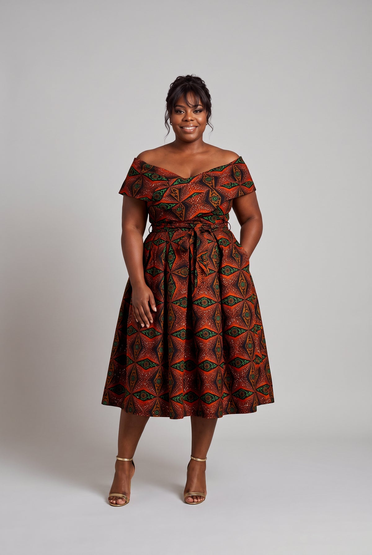 Plus size model wearing Copper Star Ankara wedding guest dress