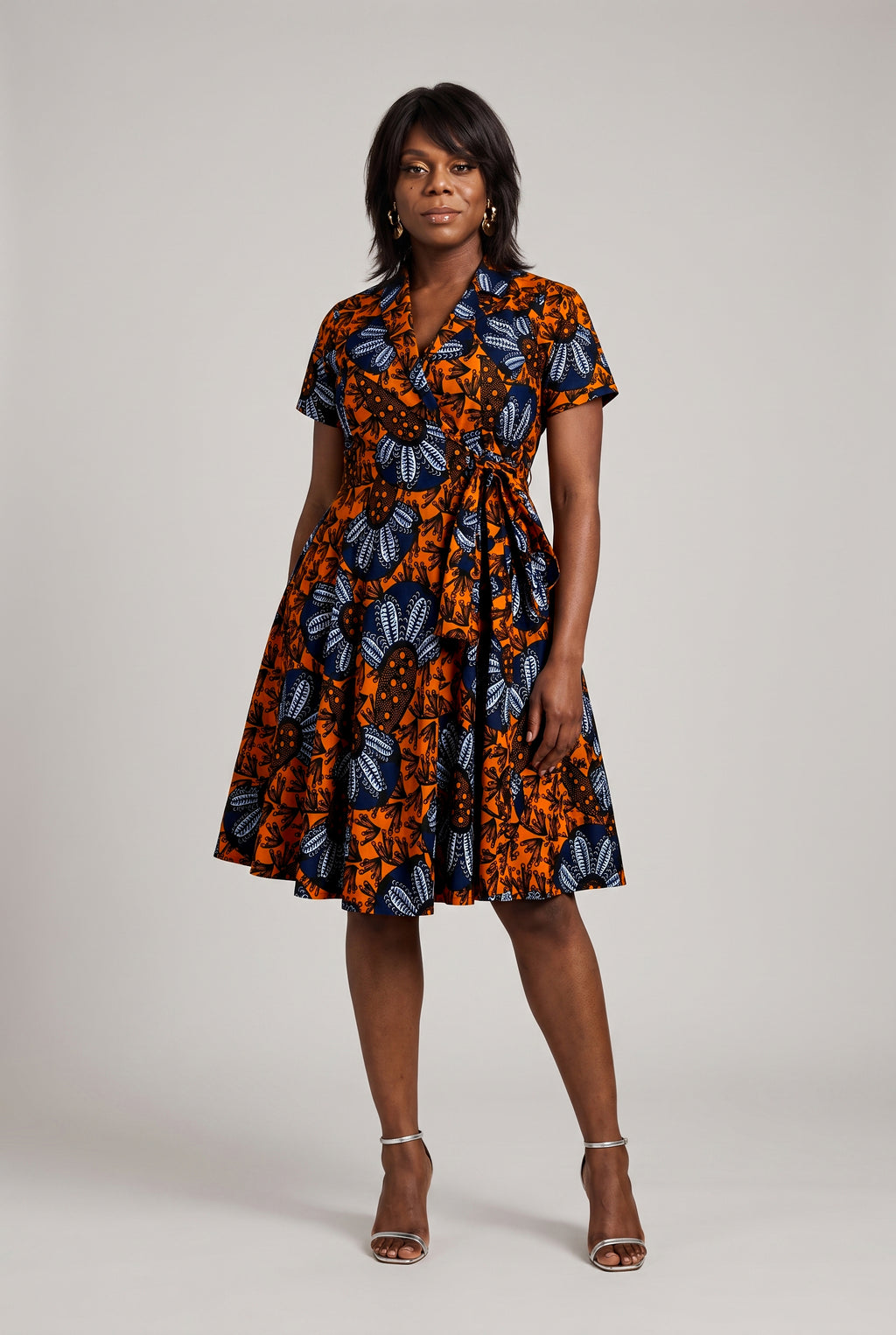 Full-length front view of African wax print wrap dress with pockets 