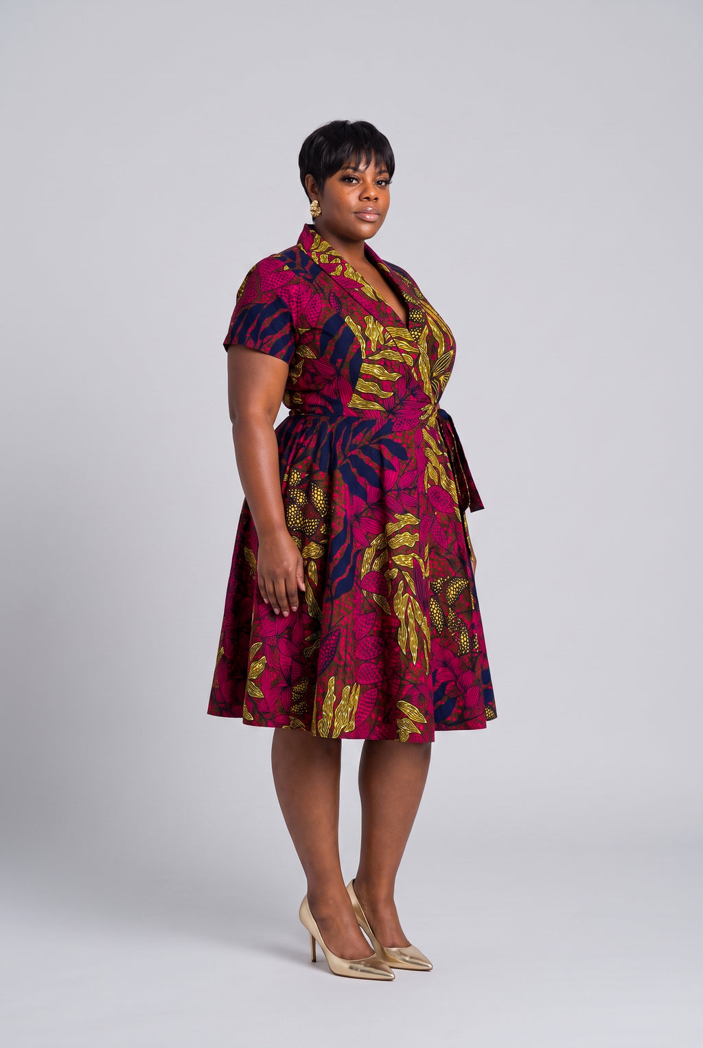 A curvy model showcasing a comfortable African wrap dress for plus size women 