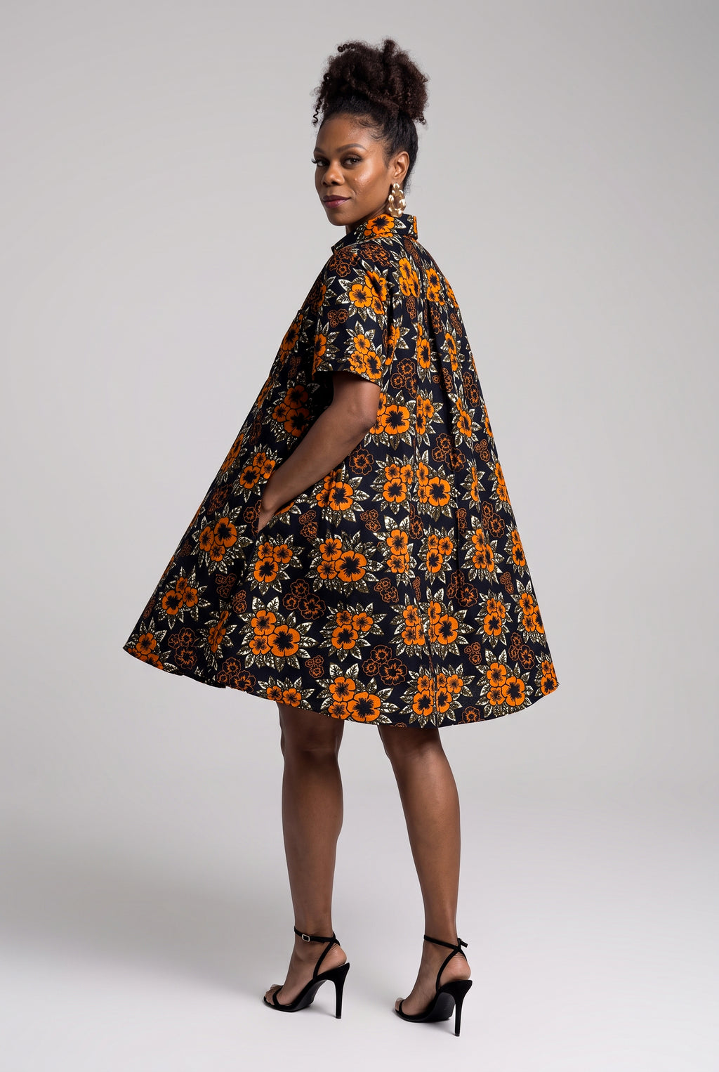 Back view of orange African print midi shirt dress