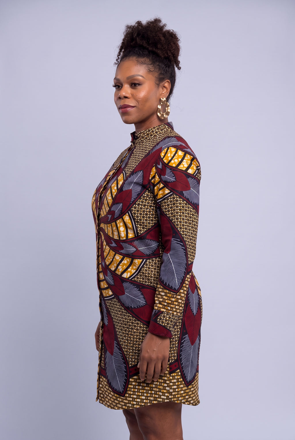 Side profile of plus size model wearing Burgundy Helix African print shirt dress