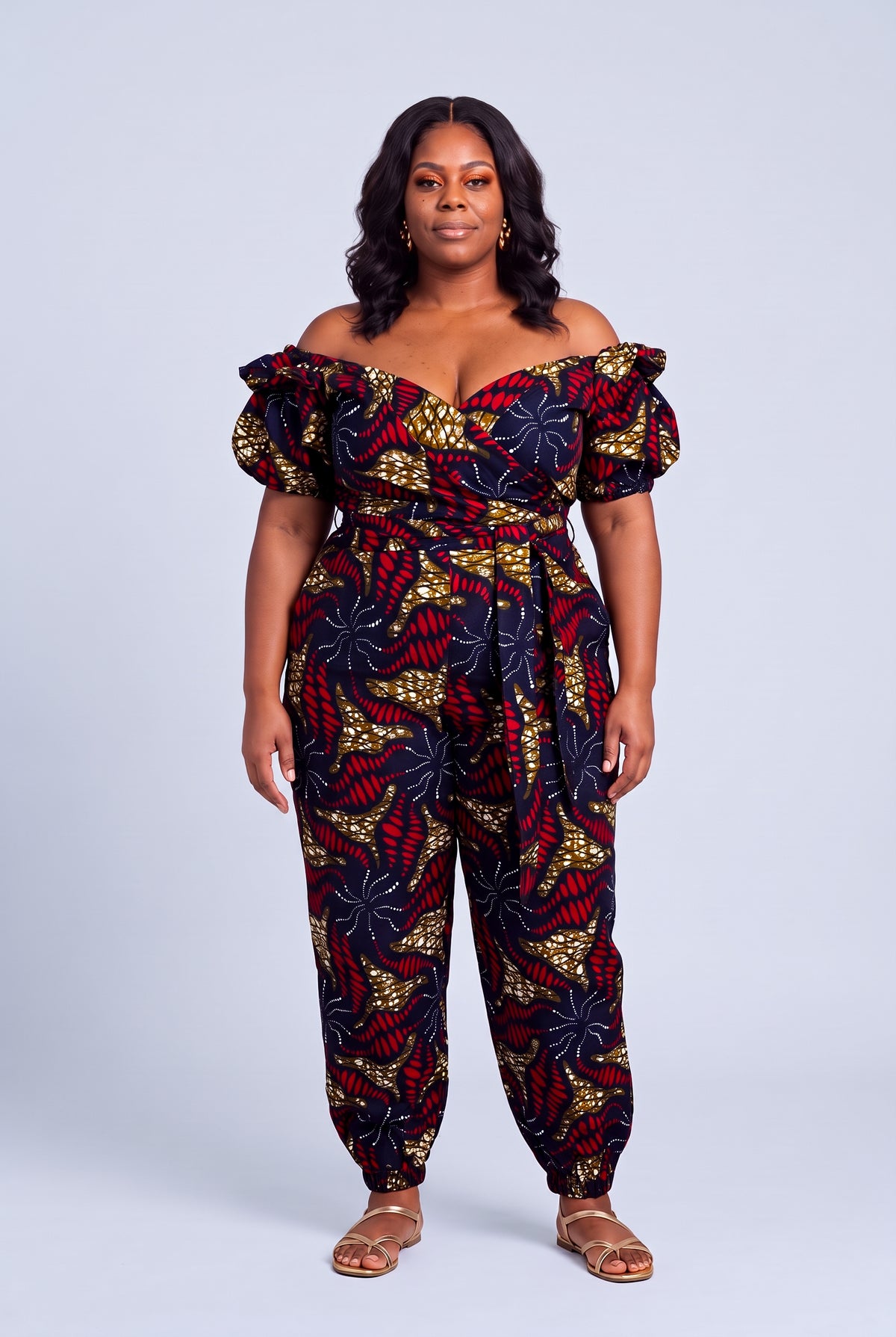 Plus size model wearing a navy blue and red Ankara matching set styled as a premium luxury resort holiday outfit