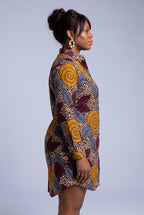  Close side view of Ochre Grove Ankara dress showing the stand collar, button front and botanical wax print