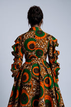 Detail view of orange green and bronze Ankara wax print fabric