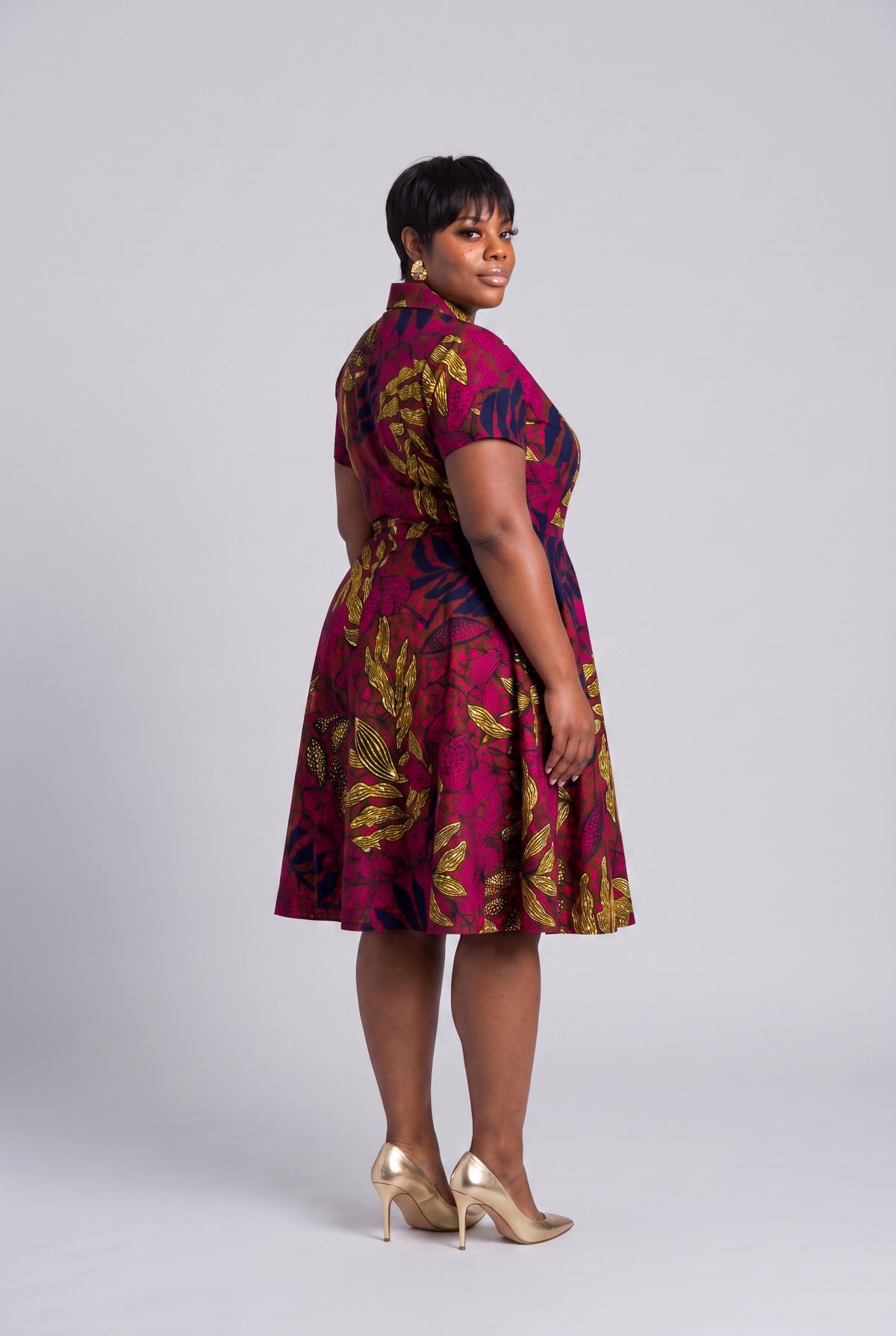 Plus size woman back view of pink African wrap dress in Ankara wax print