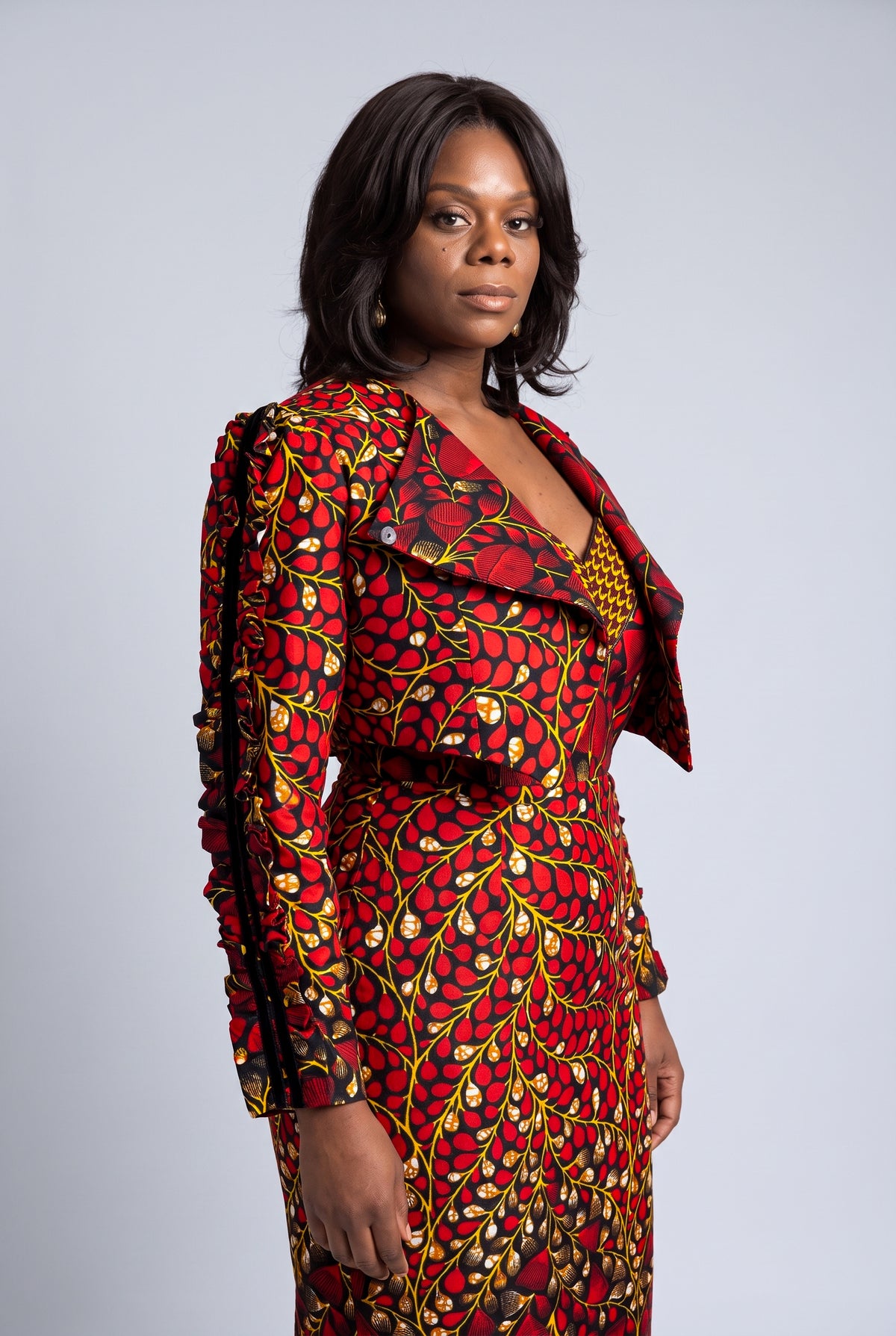 Side view of red and black Ankara corset dress with cropped jacket