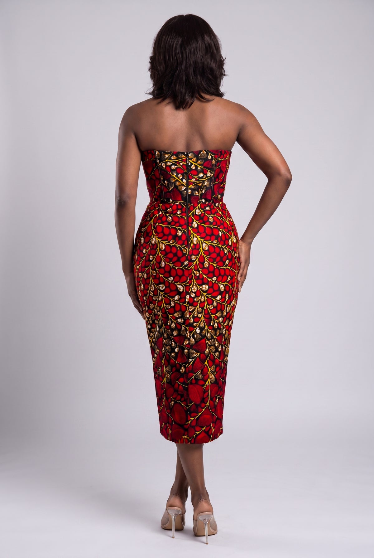 Back view of red African print fitted corset midi dress