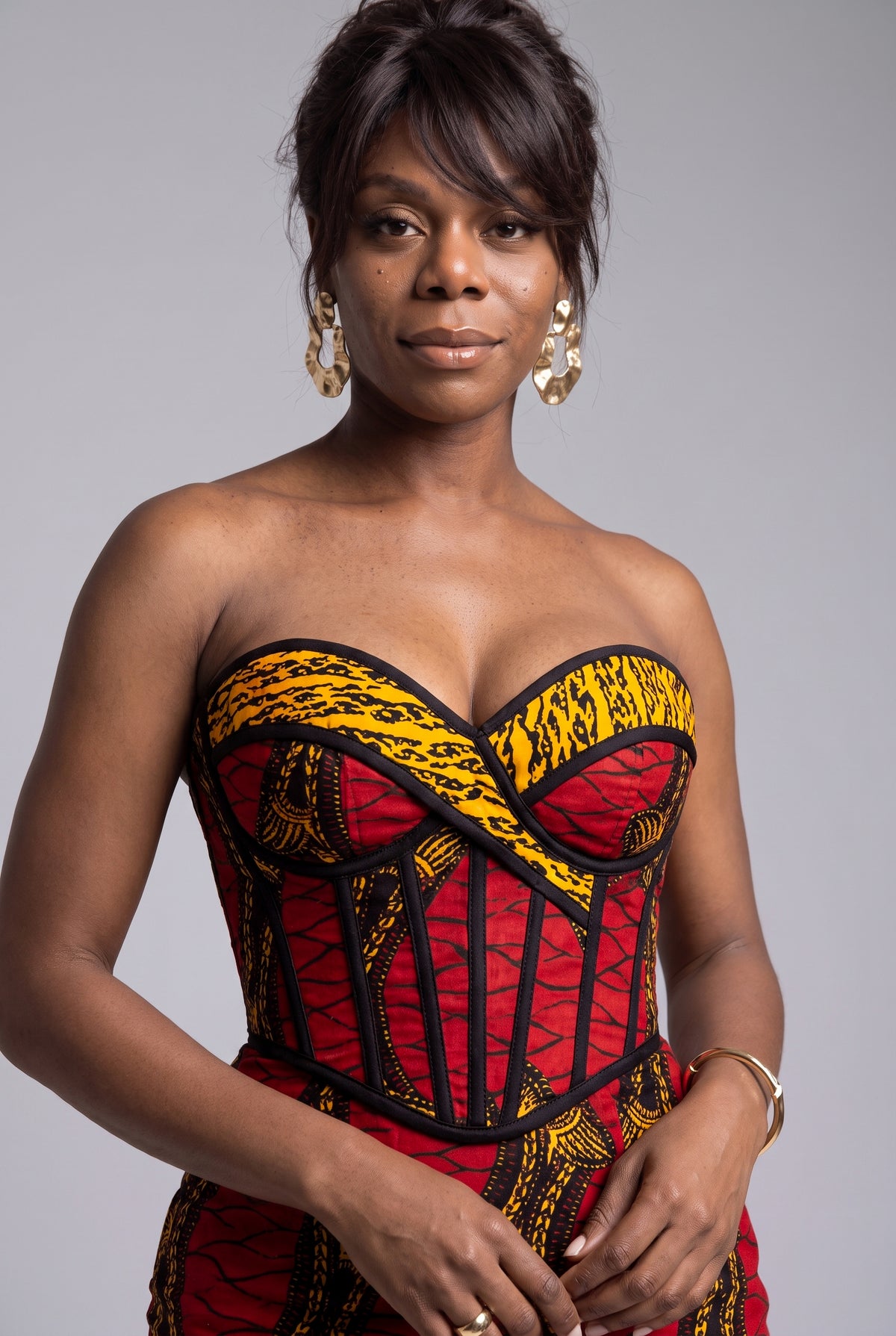 Detailed close up view of Red Grid African print strapless corset midi dress