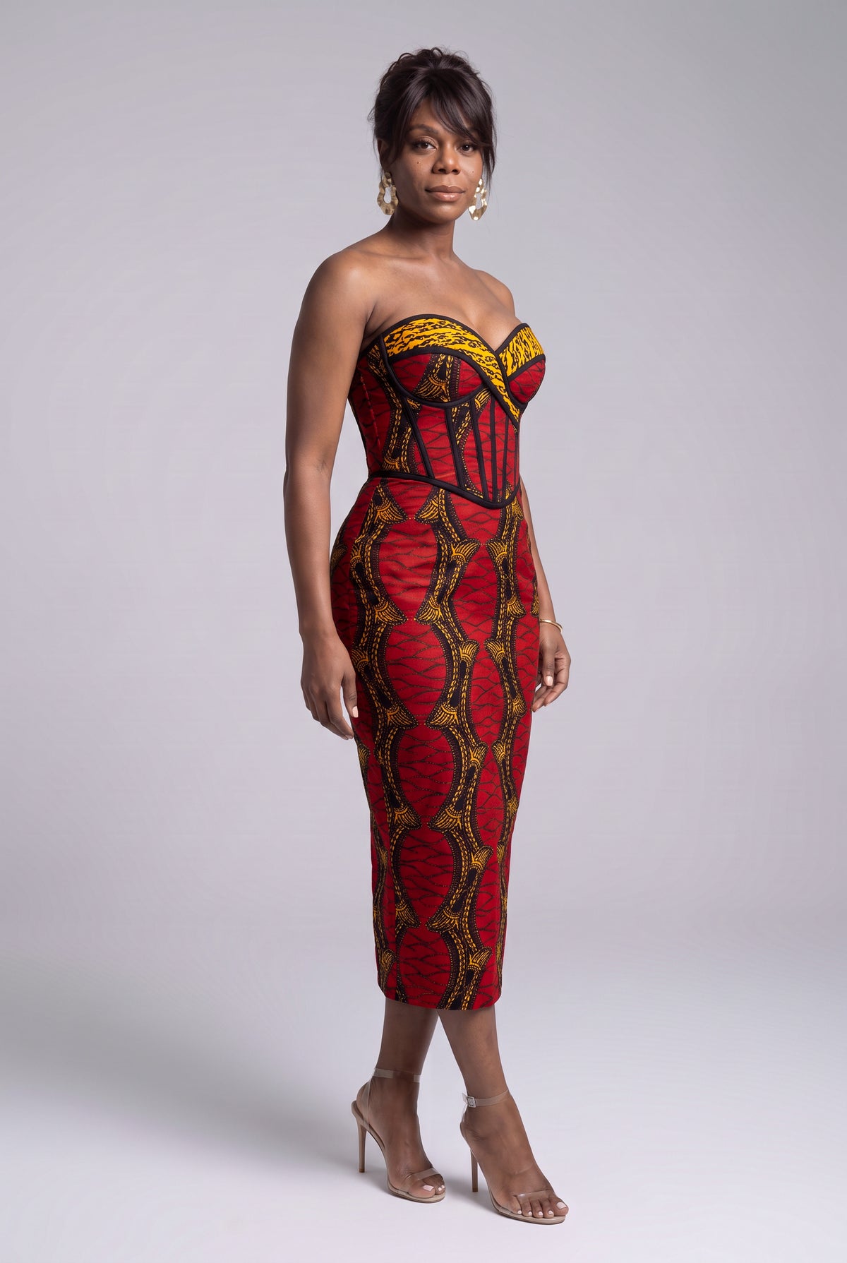 Side view of Red Grid red gold and black Ankara corset dress