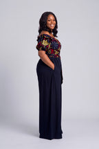 Side profile of Ruby Nova navy African print wrap top with solid navy palazzo trousers 