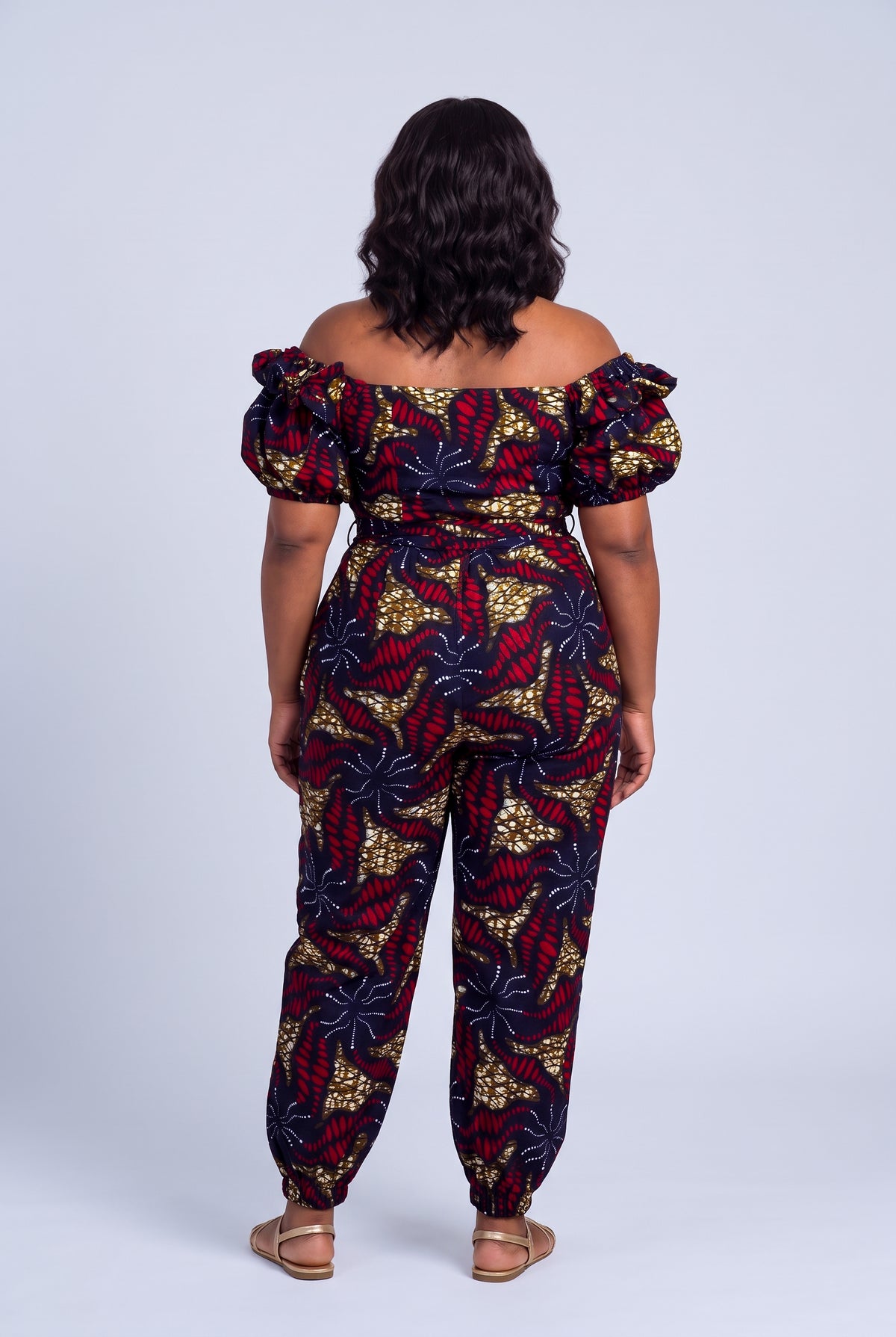Back view of navy African print wrap top and matching trousers
