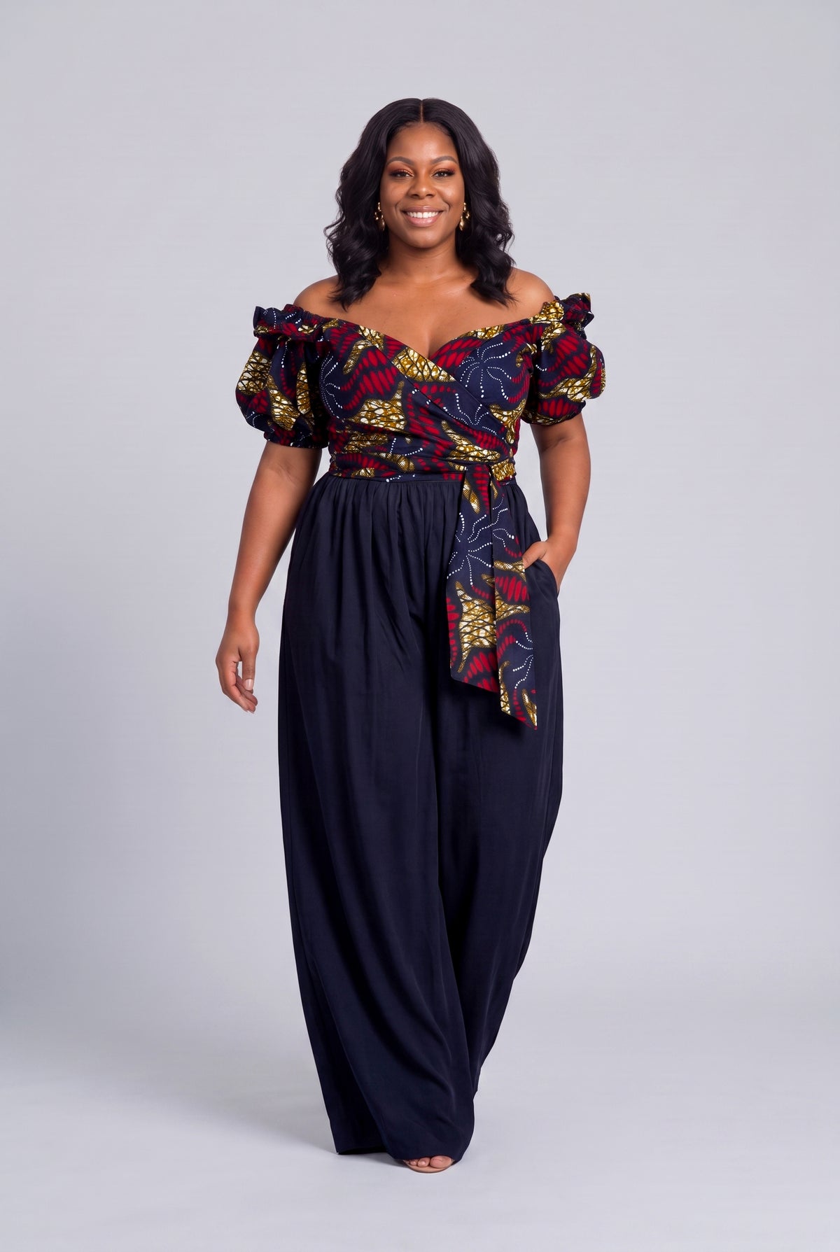 Plus size model wearing Ruby Nova navy Ankara wrap top