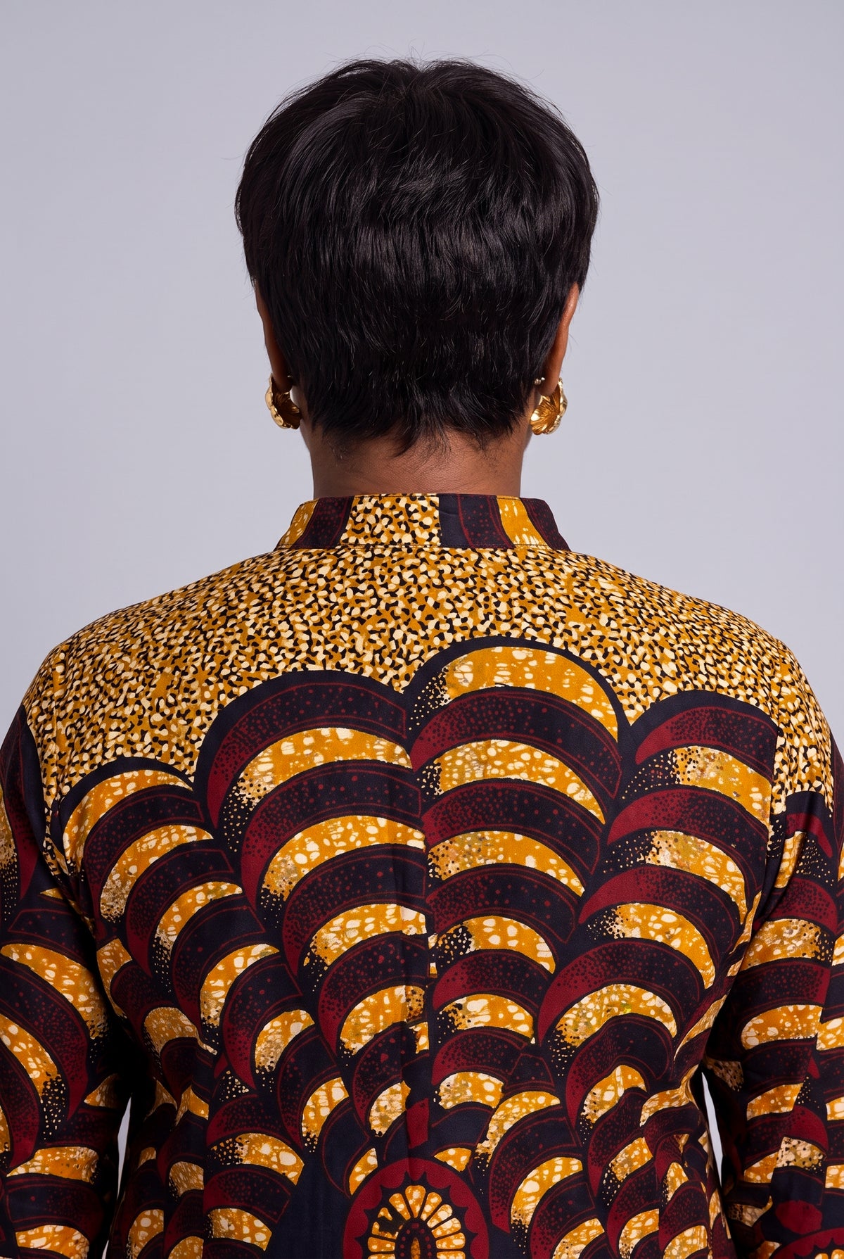 Close up back view of Saffron Halo Ankara shirt dress showing the stand collar and gold burgundy wax print