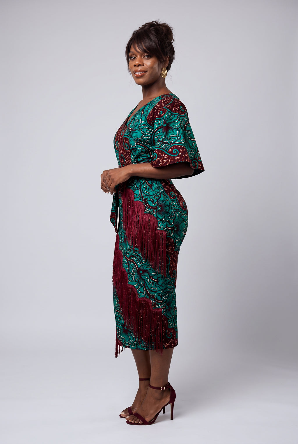 African print dress side view profile showing skirt fringe details 