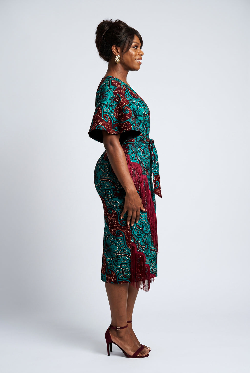 Side profile of Burgundy Oasis African print fringe midi dress