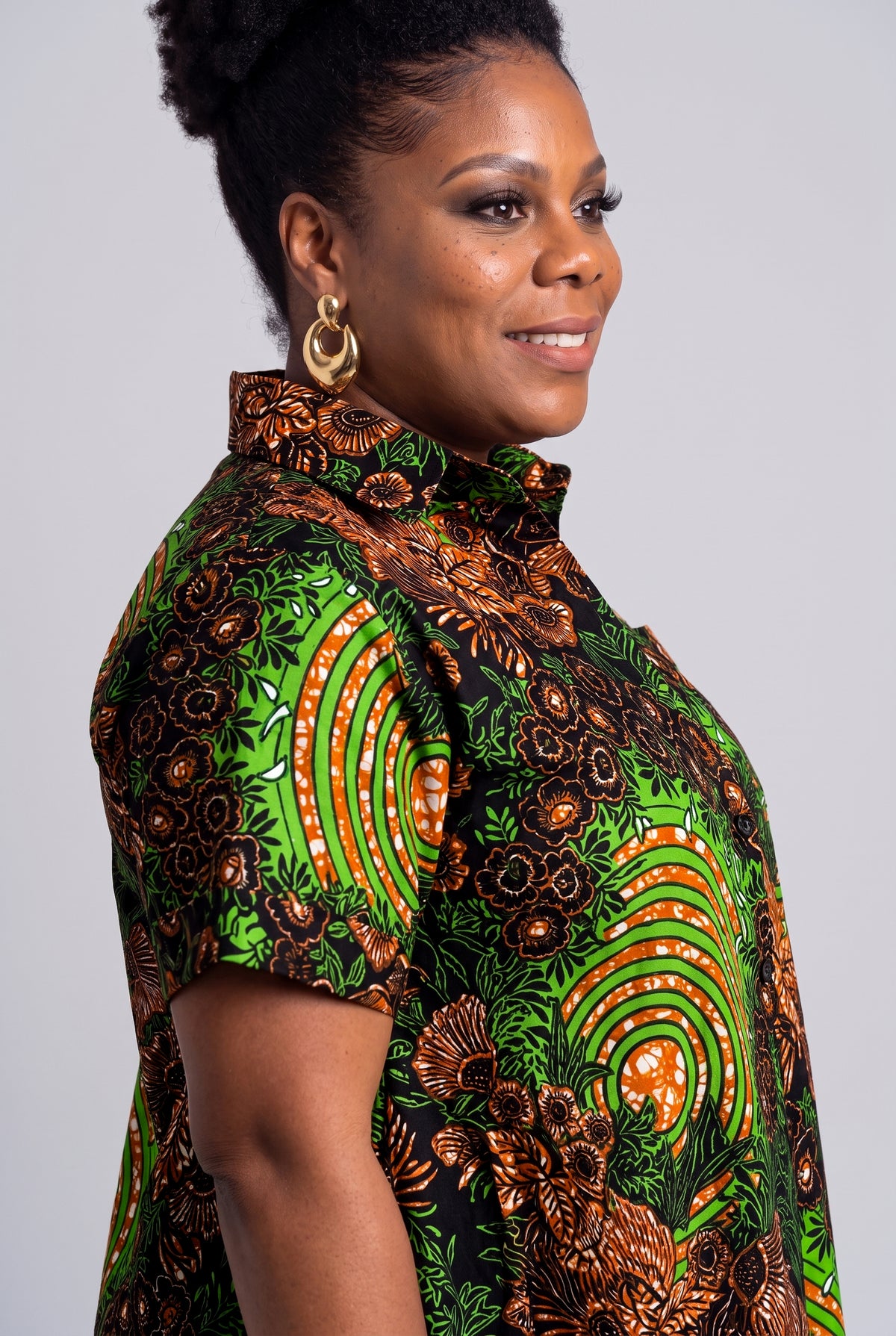 Close up of the green lime and copper botanical geometric Ankara wax print on the Verdant Ripple dress