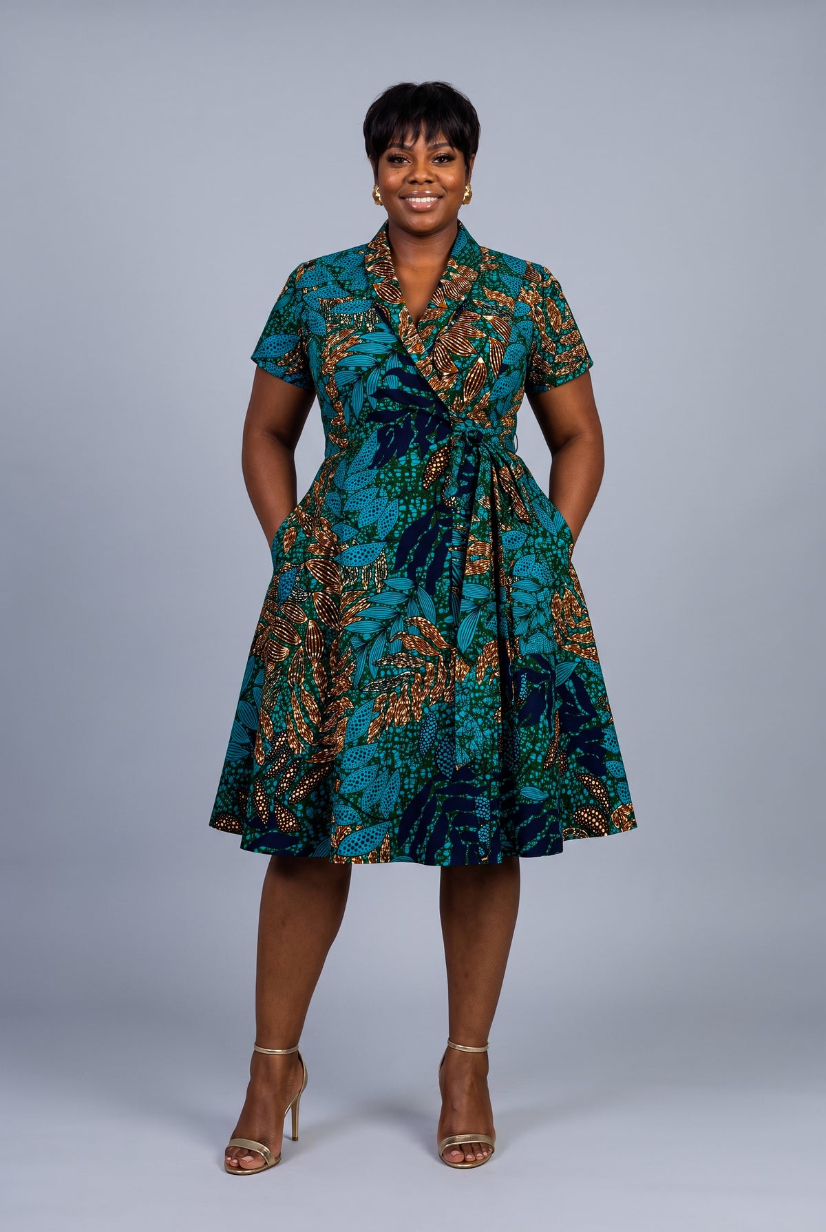 Front view of Copper Canopy teal African print wrap dress 