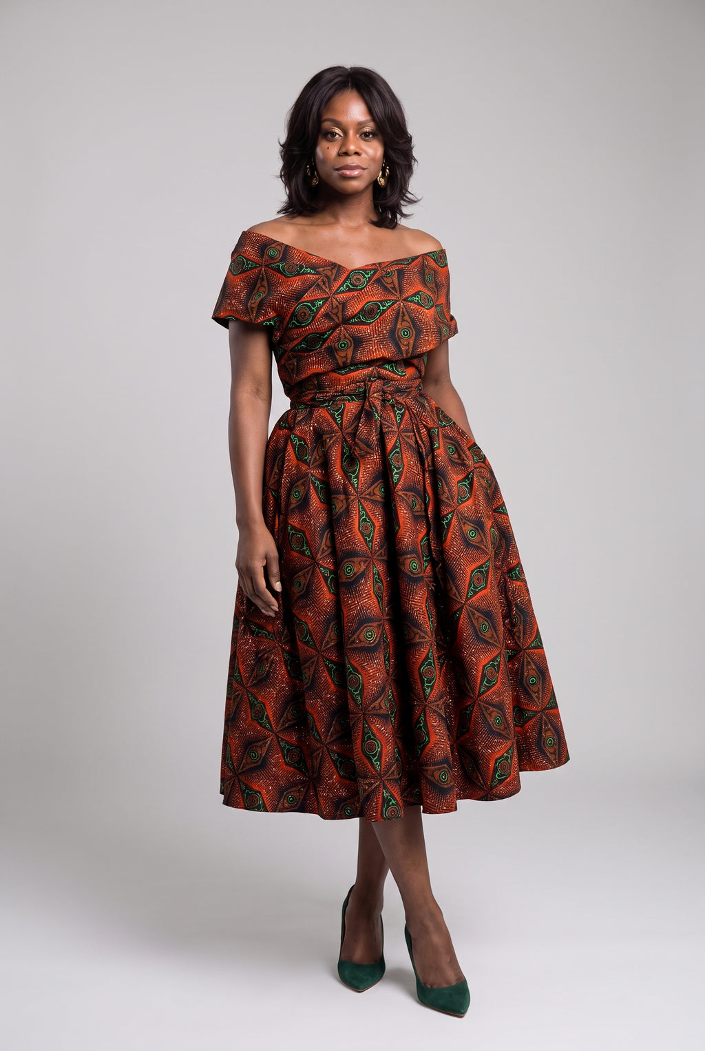 Front view of Copper Star orange African print off shoulder dress