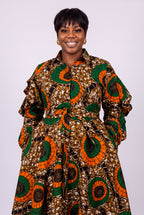 Plus size model wearing Bronze Sun orange Ankara shirt dress