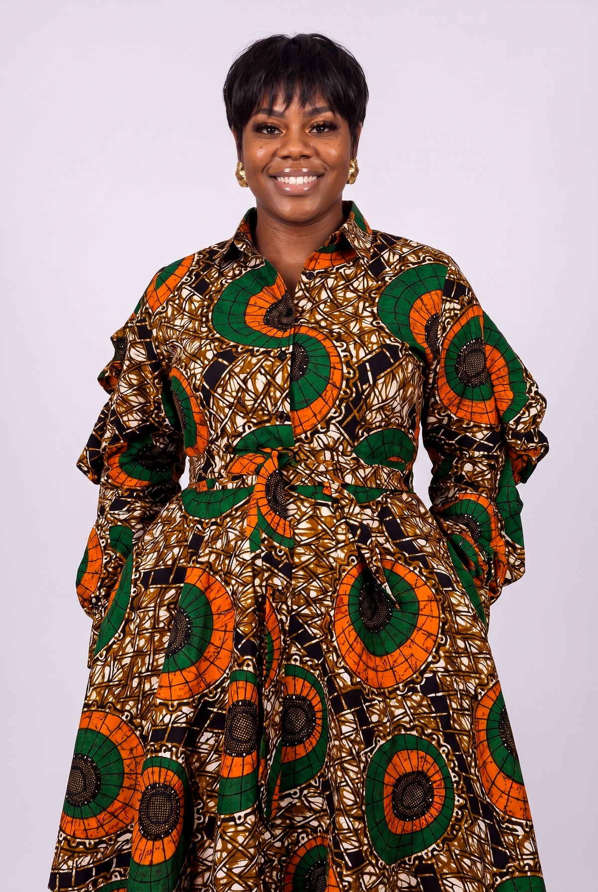 Plus size model wearing Bronze Sun orange Ankara shirt dress