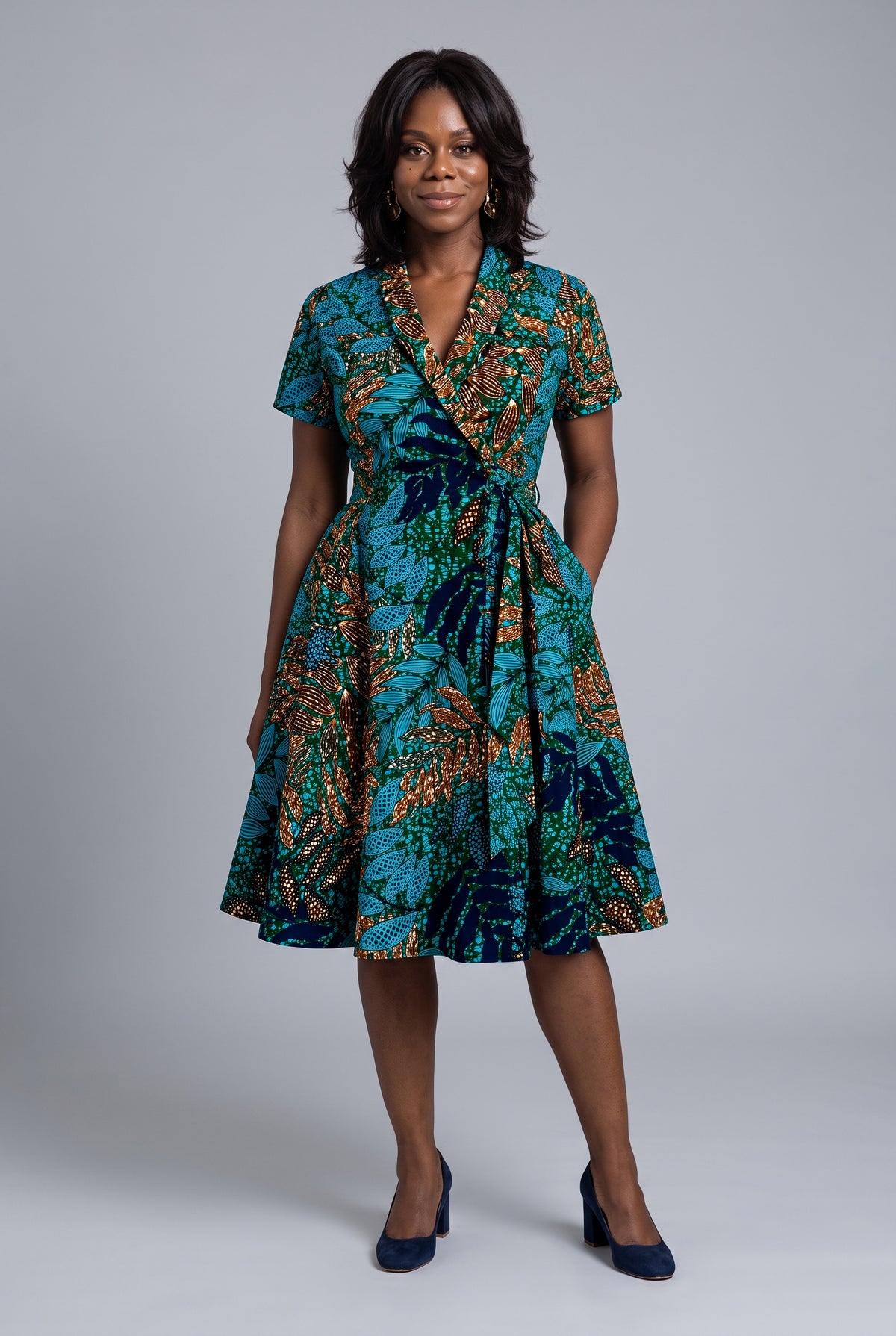 Front view of African print wrap dress with hand in pocket 