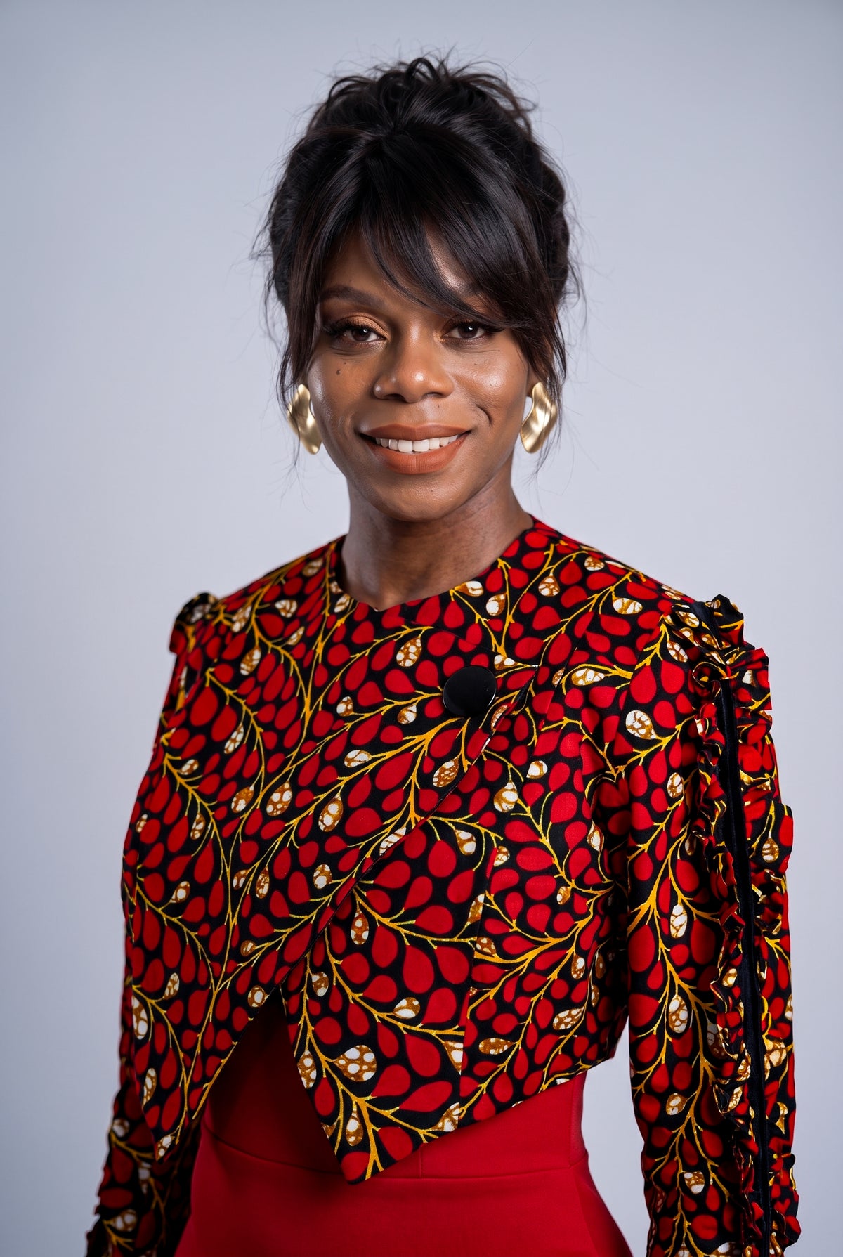 Close up of Red Vine ruffle sleeve and cropped jacket detail