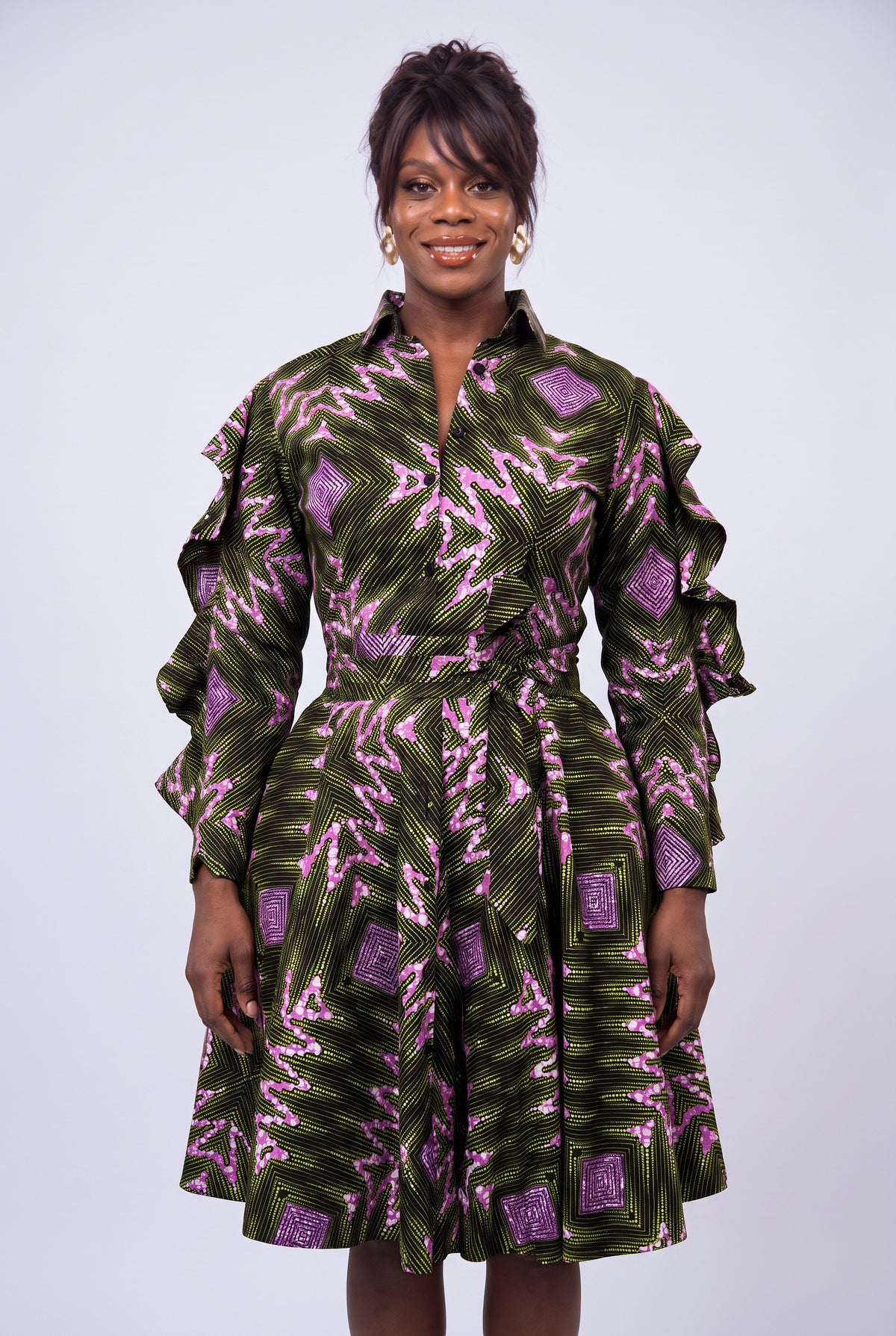 Detail view of green and pink geometric Ankara wax print fabric