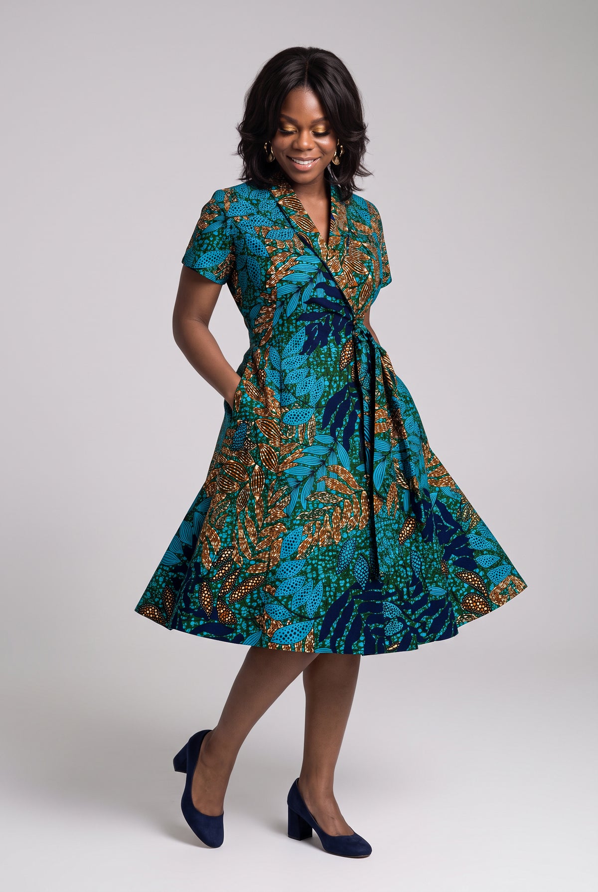Model twirling in African wrap dress, front view 
