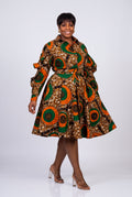 Model walking in Bronze Sun Ankara shirt dress with side pockets